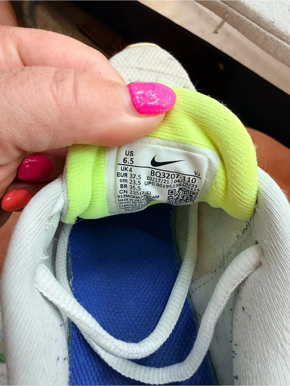Nike Women’s Revolution Sneakers in Cream with Light Purple Swoosh